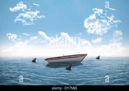 Sharks circling small boat in the ocean Stock Photo