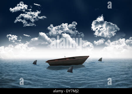 Sharks circling small boat in the sea Stock Photo