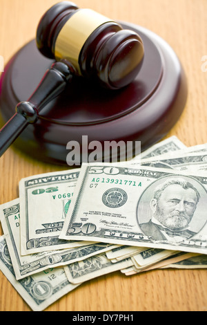 judge gavel and dollars on wooden table Stock Photo