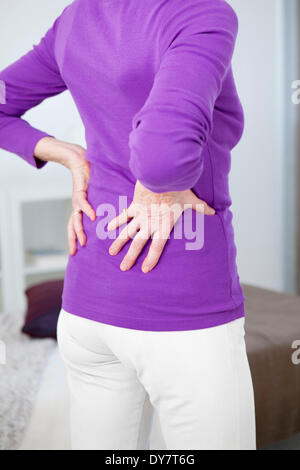 Lower back pain in elderly person Stock Photo