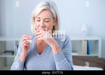 Elderly person sneezing Stock Photo