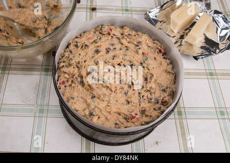 rich fruit cake mix in baking tin/pan ready to cook on a pale background bowl in background (8 of 35) Stock Photo