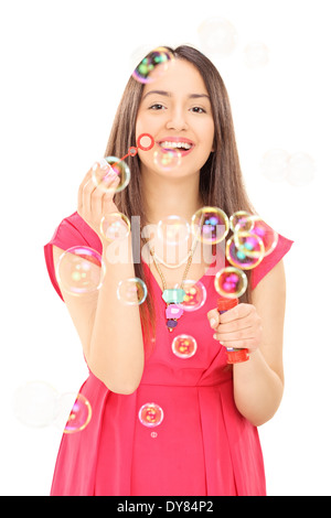 Happy girl blowing bubbles Stock Photo