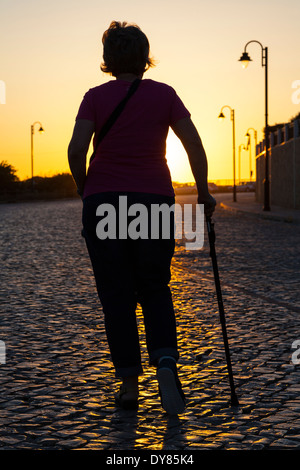 Woman with walking stick Stock Photo