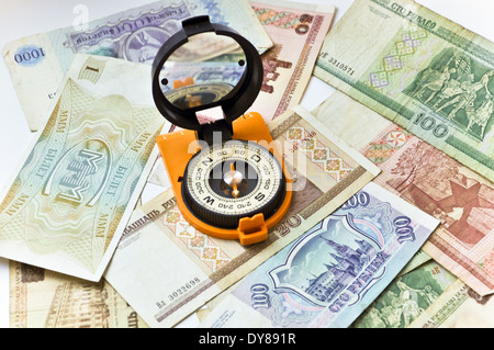 Banknotes and compass. Navigation in the world of Finance. On a white background are old banknotes, is a compass. Stock Photo