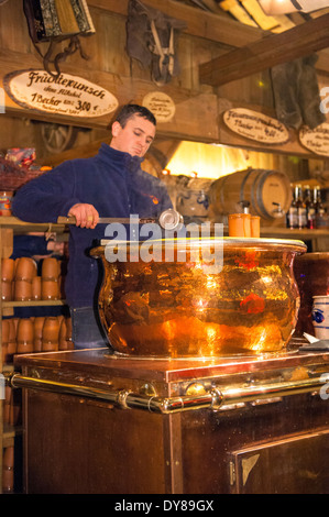 German man making Gluhwein at Christmas market, Wurzburg, Germany Stock Photo