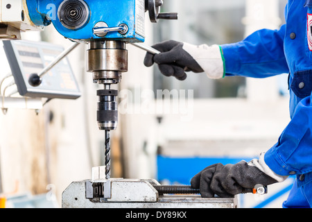 Craftsman drilling metal with drill in workshop Stock Photo Alamy