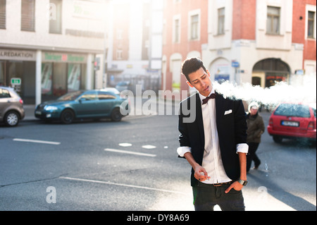 Smoking young man in the city Stock Photo
