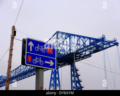 Image of Historic transporter bridge at Middlehaven, Middlesbrough, Teesside, UK, crossing industrial River Tees Stock Photo