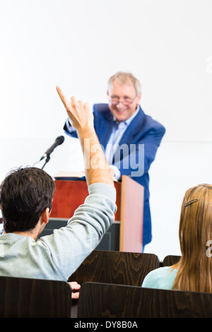 Students listening to college professor giving lecture Stock Photo