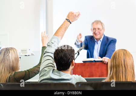 Students listening to college professor giving lecture Stock Photo