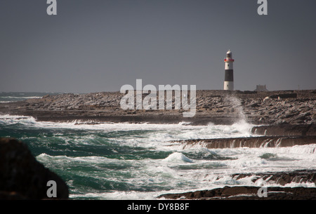 Lighthouse on stormy rocky shoreline of Inis Oirr on the Aran Islands in Ireland Stock Photo