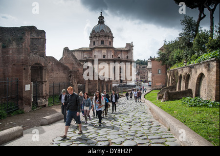 Tourists walking inside the ancient forum in Rome Stock Photo