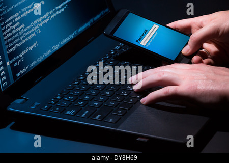 Hacker using laptop. Lots of digits on the computer screen. Stock Photo
