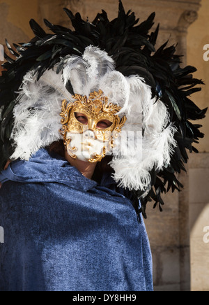 Close up portrait of man on traditional Venice carnival rococo costume, gold mask and elaborate feather hat for the famous festival, Venice Italy Stock Photo