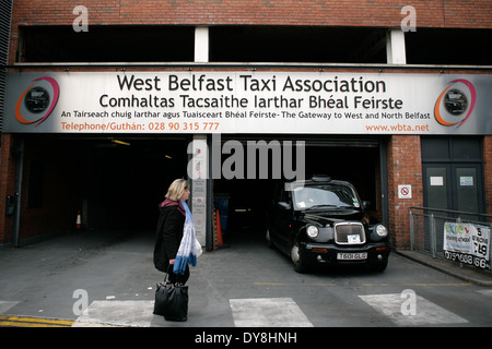 Belfast,Northern Ireland, UK.Woman on Crossing outside West Belfast Taxi Association Depot. Stock Photo