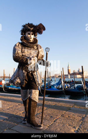 Man in full historic costume and boots posing in afternoon sunlight Venice carnival Stock Photo