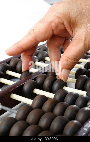 Hand using an abacus Stock Photo - Alamy