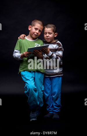 Boys using electronic tablet Stock Photo