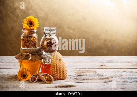 Decorative display with jars of fresh honey, flower pollen and propolis Stock Photo