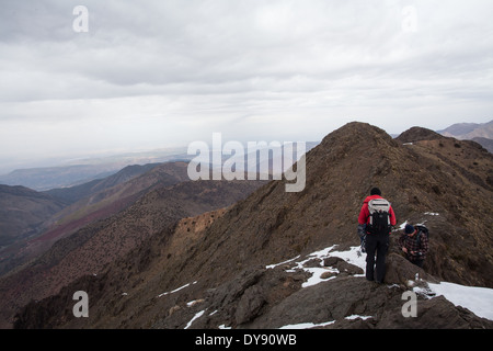 Walkers cross a ridge in the Atlas Mountains Stock Photo