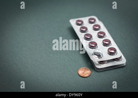 Euro cent coin in blister pack isolated on green background Stock Photo