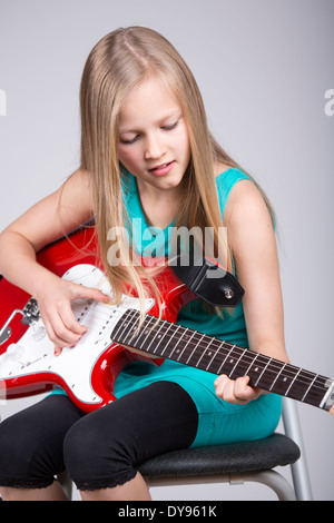 blond girl playing with an electric guitar Stock Photo - Alamy