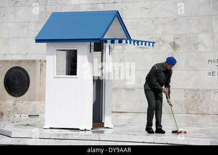 Athens, Greece. 10th Apr, 2014. A Greek soldier wipes the rainwater in front of the monument of the Unknown Soldier in Syntagma Square. Evzones perform the Changing of the Guard Ceremony at the Tomb of the Unknown Soldier in Syntagma Square in Athens, Greece on April 10, 2014. Credit:  Konstantinos Tsakalidis/Alamy Live News Stock Photo