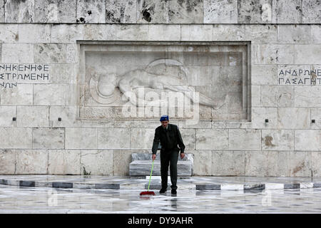 Athens, Greece. 10th Apr, 2014. A Greek soldier wipes the rainwater in front of the monument of the Unknown Soldier in Syntagma Square. Evzones perform the Changing of the Guard Ceremony at the Tomb of the Unknown Soldier in Syntagma Square in Athens, Greece on April 10, 2014. Credit:  Konstantinos Tsakalidis/Alamy Live News Stock Photo