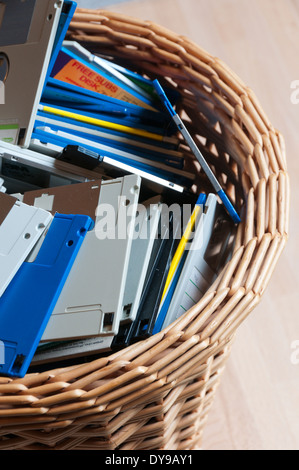 Old 3.5" computer disks thrown away in a waste paper basket. Stock Photo