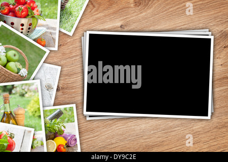 Stack of printed pictures collage on wooden table with copy space for your photo Stock Photo