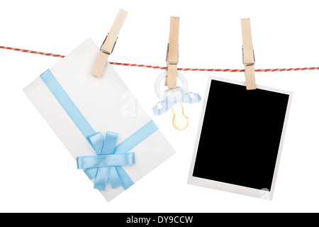 Instant photo, gift letter and pacifier hanging on the clothesline. Isolated on white background Stock Photo