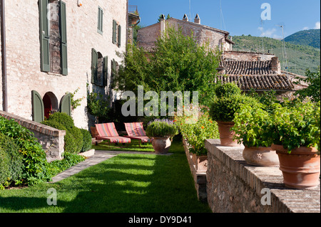 Potted plants and sunloungers in garden of Umbrian villa Stock Photo