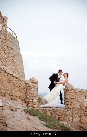 Engaged couple kissing after wedding Stock Photo