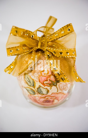 Easter egg decorated with flowers made by decoupage technique on light background Stock Photo