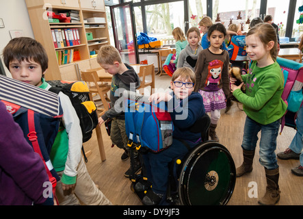 Non-disabled and disabled students (in this case a boy in a wheel chair) learn together in the same class in a primary school. Stock Photo