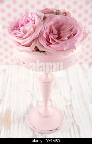 Pink roses in a wooden pastel color vase on vintage white wooden shabby chic background Stock Photo