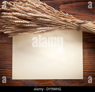 Ears of wheat on old wooden table. Stock Photo