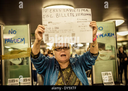 Barcelona, Spain. April 10th, 2014: An activist holds her placard during a protest against the raised fare for Barcelona's public transportation Credit:  matthi/Alamy Live News