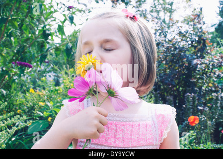 Little girl smelling flower Stock Photo