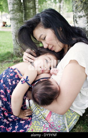 Mother with baby and little girl outdoors Stock Photo