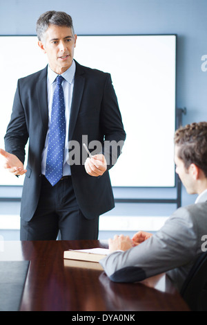 Business executive giving presentation at meeting Stock Photo