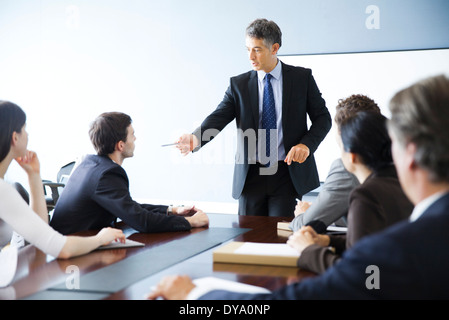 Business executive giving presentation at meeting Stock Photo