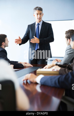 Business executive giving presentation at meeting Stock Photo