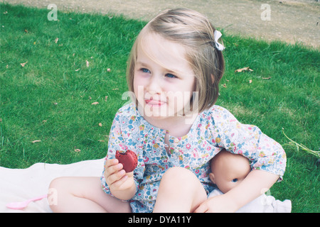 Little girl eating macaroon Stock Photo