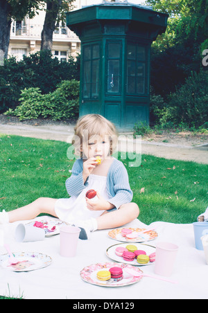 Little girl eating macaroon Stock Photo