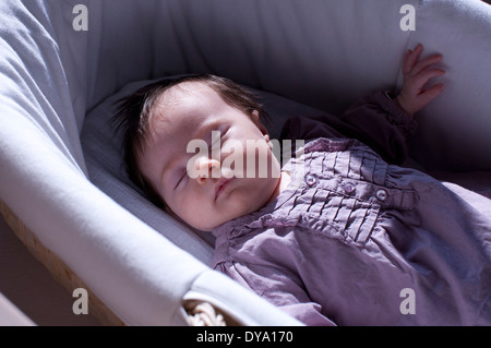 Baby sleeping in crib Stock Photo