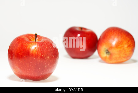 three nice red juicy apples on white sheet Stock Photo