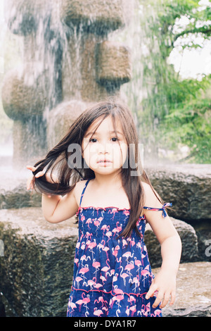 Little girl by water fountain, portrait Stock Photo