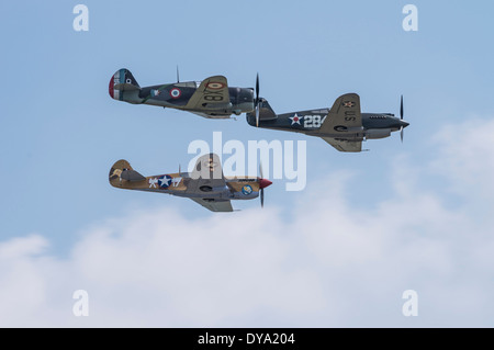 Curtiss H75A-1 Hawk and Curtiss P-40B and P-40F Warhawks in formation at the Flying Legends Airshow, Imperial War Museum Duxford Stock Photo
